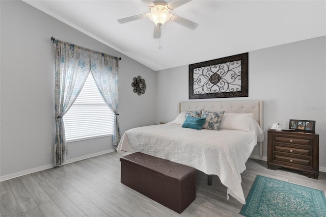 bedroom with light hardwood / wood-style flooring, ceiling fan, and vaulted ceiling