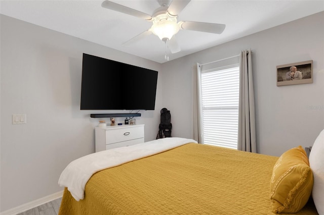 bedroom with hardwood / wood-style flooring and ceiling fan