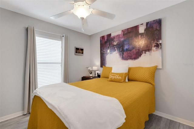 bedroom with wood-type flooring and ceiling fan