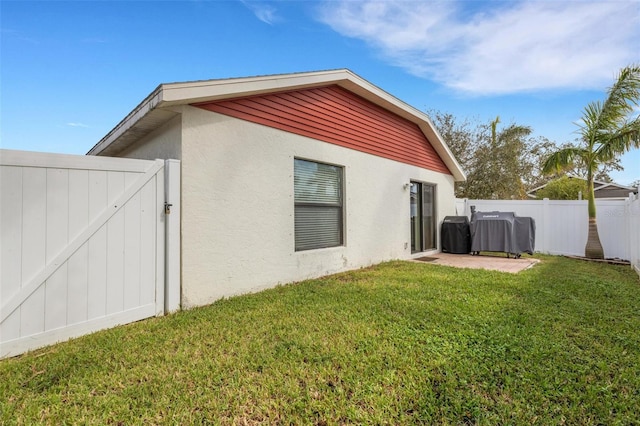 back of property featuring a patio area and a lawn