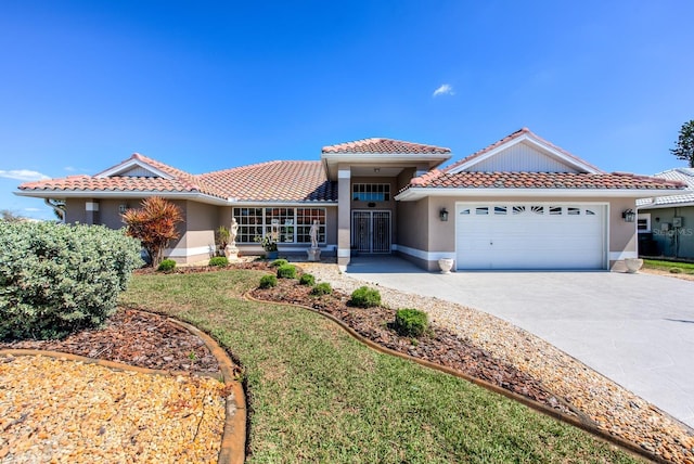 view of front of house featuring a garage, driveway, a tile roof, and stucco siding