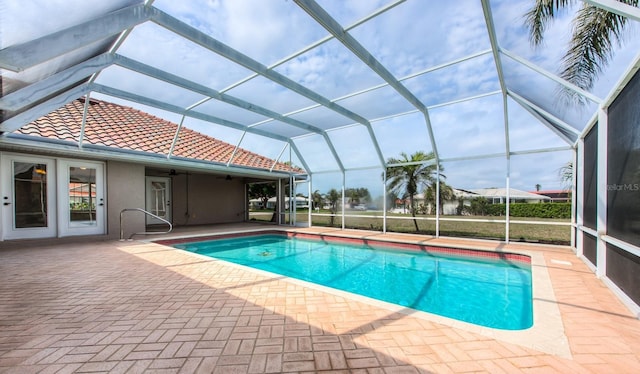 outdoor pool featuring a lanai, a ceiling fan, and a patio