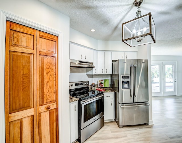 kitchen featuring decorative light fixtures, appliances with stainless steel finishes, white cabinetry, a textured ceiling, and under cabinet range hood