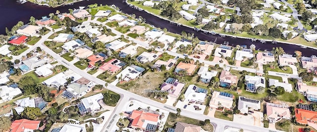 drone / aerial view featuring a water view and a residential view