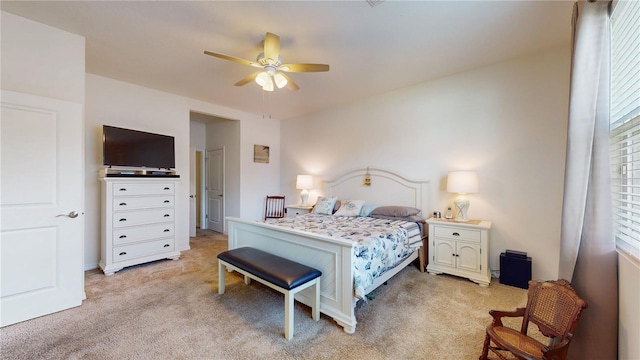 bedroom with ceiling fan and light carpet