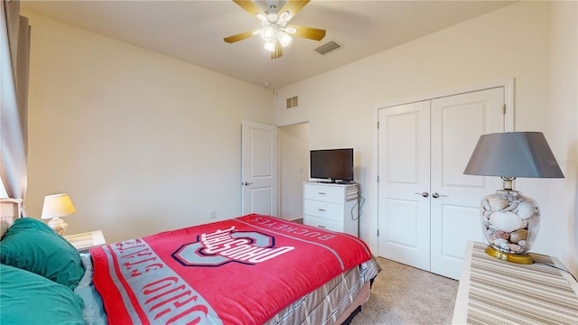 bedroom featuring light carpet, a closet, and ceiling fan