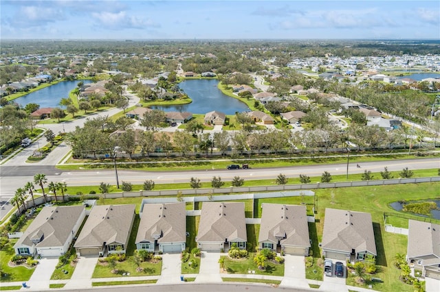 birds eye view of property with a water view