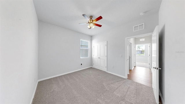 3718 Mossy Limb Ct, Palmetto, FL 34221 - unfurnished bedroom featuring multiple windows, carpet floors, baseboards, and a ceiling fan