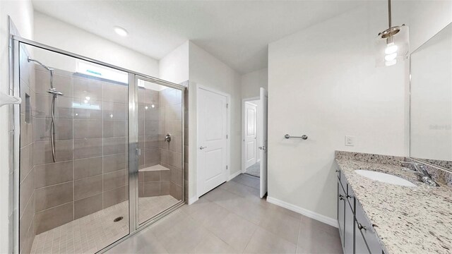 3718 Mossy Limb Ct, Palmetto, FL 34221 - bathroom with vanity, a shower stall, baseboards, and tile patterned floors
