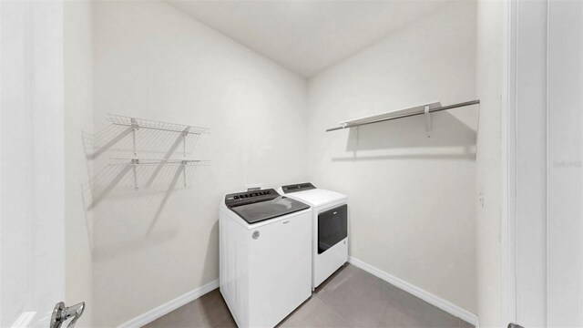 3718 Mossy Limb Ct, Palmetto, FL 34221 - laundry area with washing machine and dryer, baseboards, and tile patterned floors