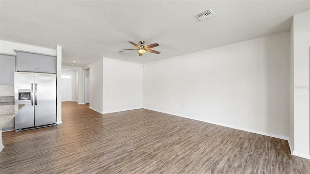 3718 Mossy Limb Ct, Palmetto, FL 34221 - unfurnished living room with a ceiling fan, dark wood-style flooring, and baseboards