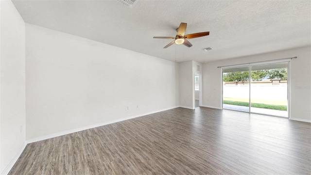 3718 Mossy Limb Ct, Palmetto, FL 34221 - spare room featuring wood finished floors, ceiling fan, baseboards, and a textured ceiling