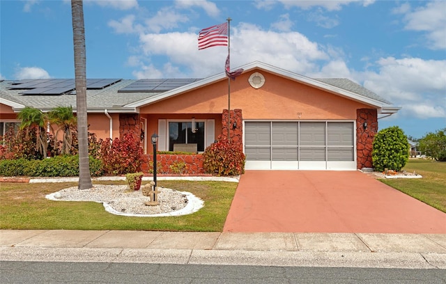 single story home featuring a front yard, a garage, and solar panels