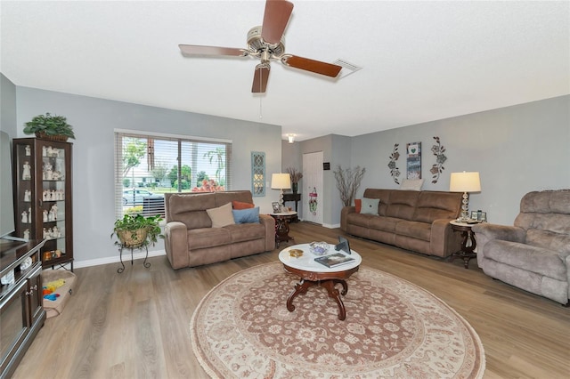 living room with light wood-type flooring and ceiling fan