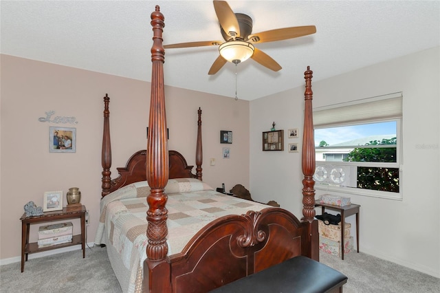 bedroom featuring light carpet, a textured ceiling, and ceiling fan