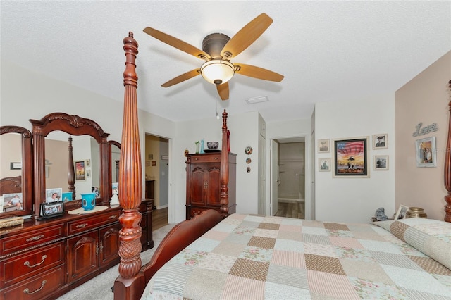 bedroom featuring ensuite bathroom, a textured ceiling, and ceiling fan