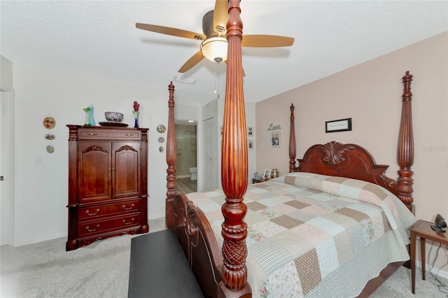 bedroom with light carpet, ensuite bathroom, and ceiling fan