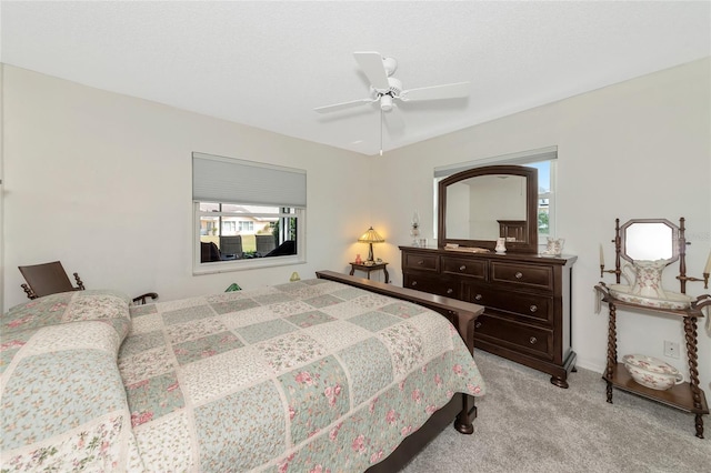 bedroom featuring light carpet and ceiling fan