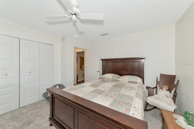 bedroom featuring light carpet, a closet, and ceiling fan