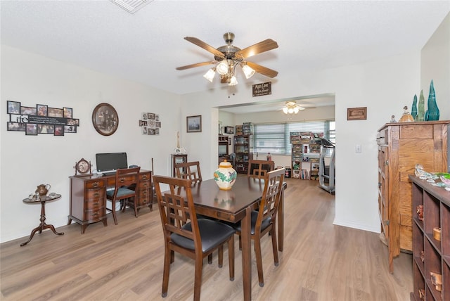 dining area featuring light wood-type flooring and ceiling fan