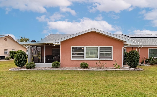 view of front of home featuring a sunroom, a front yard, and cooling unit