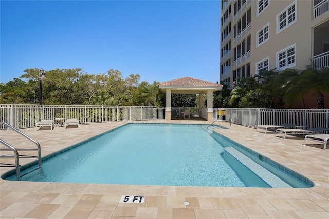 view of swimming pool with a gazebo and a patio area