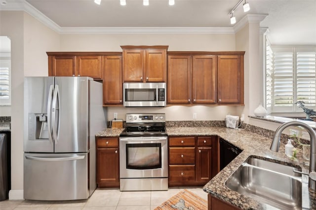 kitchen featuring stainless steel appliances, crown molding, sink, light tile patterned floors, and stone countertops