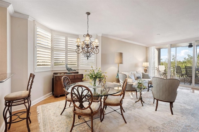 dining area with light hardwood / wood-style floors, plenty of natural light, and ornamental molding