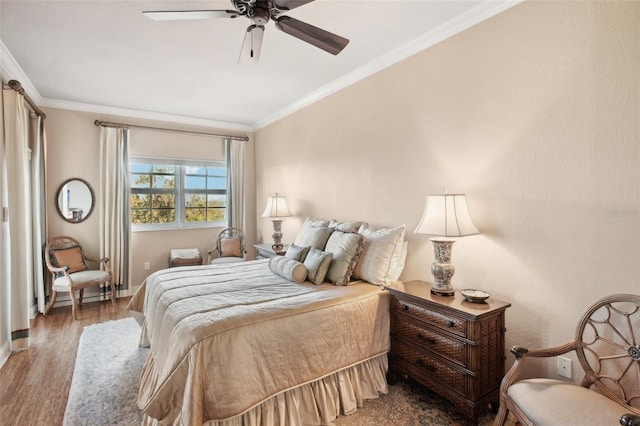 bedroom with ceiling fan, wood-type flooring, and crown molding