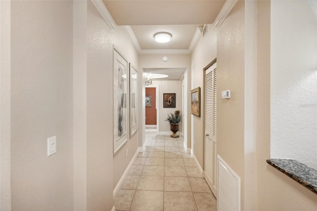 hall with crown molding and light tile patterned flooring