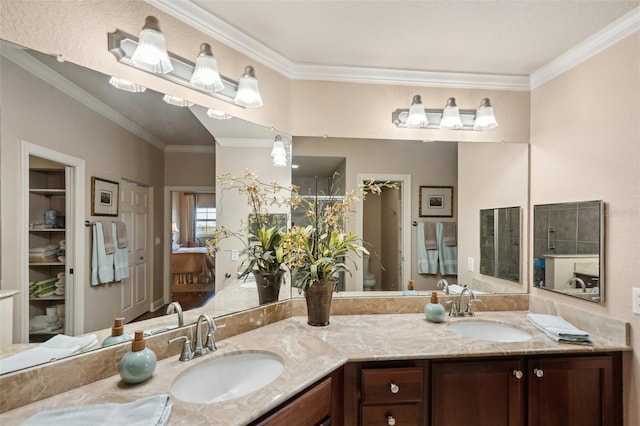 bathroom with vanity, toilet, and ornamental molding