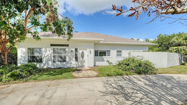1789 Loma Linda St, Sarasota, FL 34239 - view of front of property with roof with shingles, stucco siding, and a front lawn