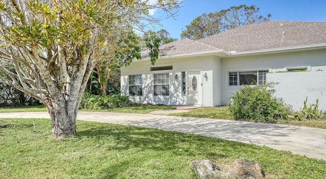 1789 Loma Linda St, Sarasota, FL 34239 - view of front of home with a shingled roof, a front yard, and stucco siding