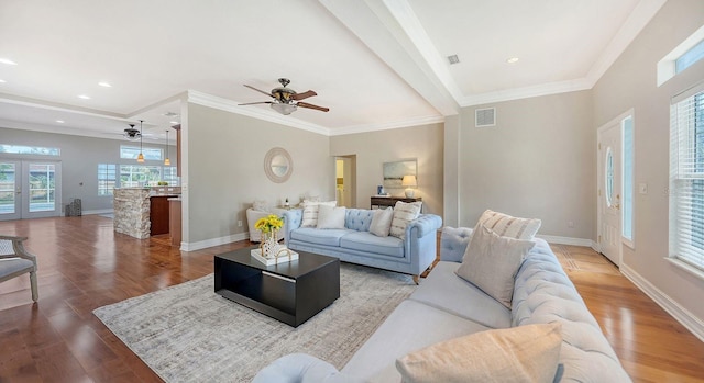 living room with ornamental molding, hardwood / wood-style flooring, and ceiling fan