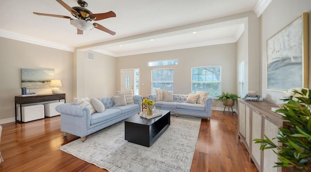 living room with ornamental molding, hardwood / wood-style flooring, and ceiling fan