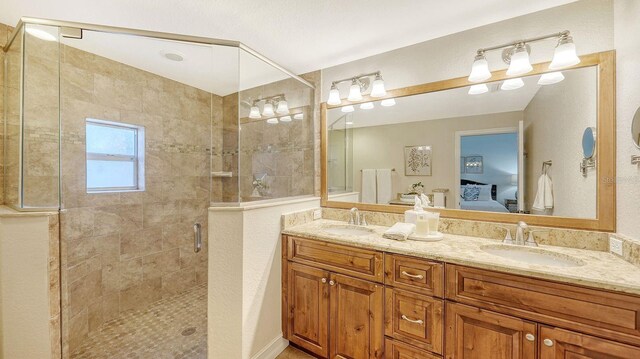 bathroom with a shower with door and vanity