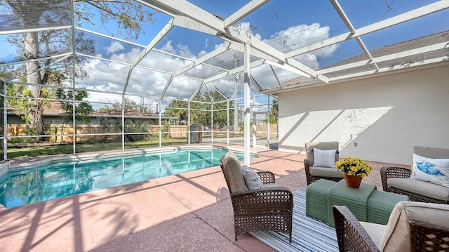 view of pool with an outdoor hangout area, a patio area, and glass enclosure