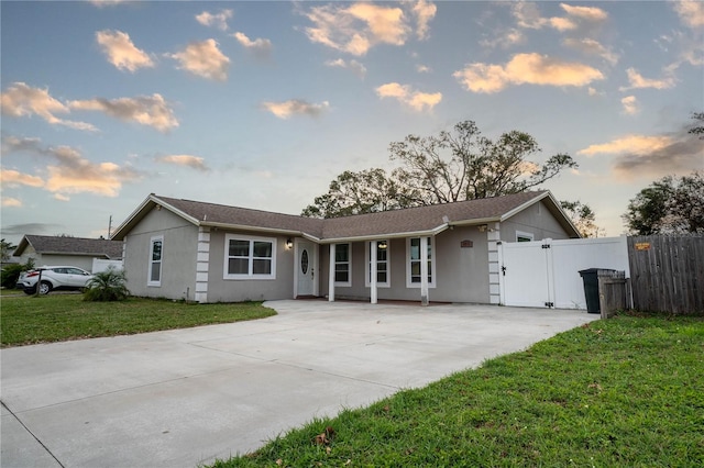 ranch-style home featuring a lawn