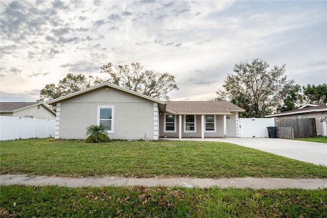 ranch-style home with a front lawn