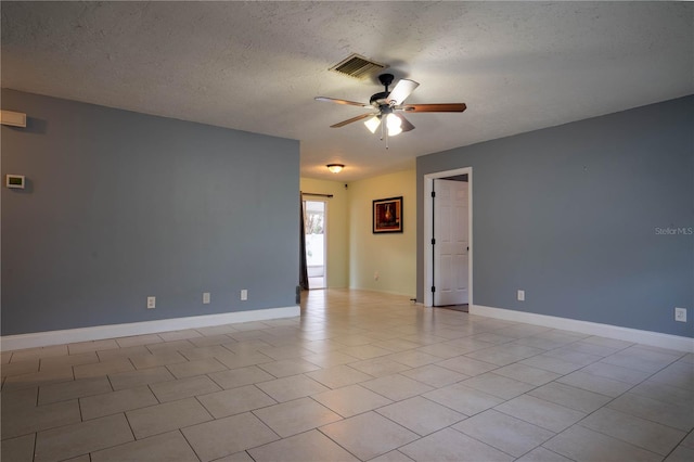 tiled empty room with ceiling fan and a textured ceiling