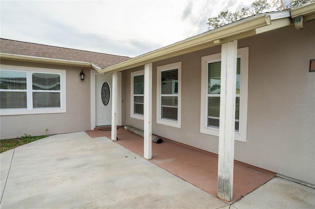 view of exterior entry featuring a patio area