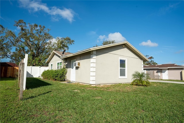 view of home's exterior with a lawn