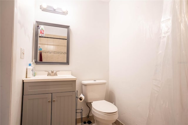 bathroom with toilet and vanity