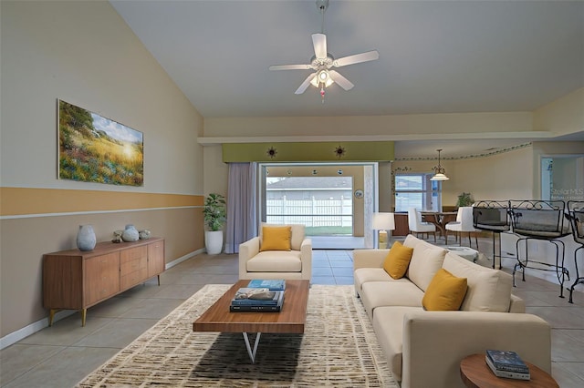 living room featuring light tile patterned flooring, ceiling fan, and vaulted ceiling