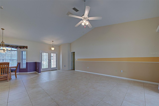 unfurnished living room featuring french doors, ceiling fan with notable chandelier, light tile patterned floors, and vaulted ceiling