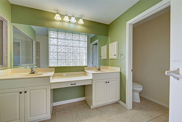 bathroom with vanity, tile patterned floors, a textured ceiling, and toilet