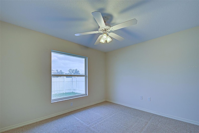 empty room with carpet flooring and ceiling fan