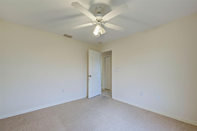 unfurnished room featuring light carpet and ceiling fan