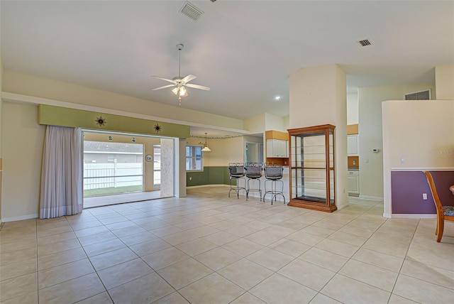 unfurnished room with ceiling fan and light tile patterned floors