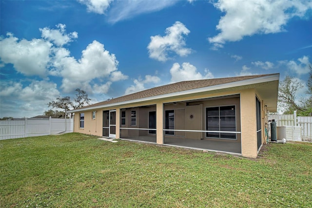 rear view of house with a lawn